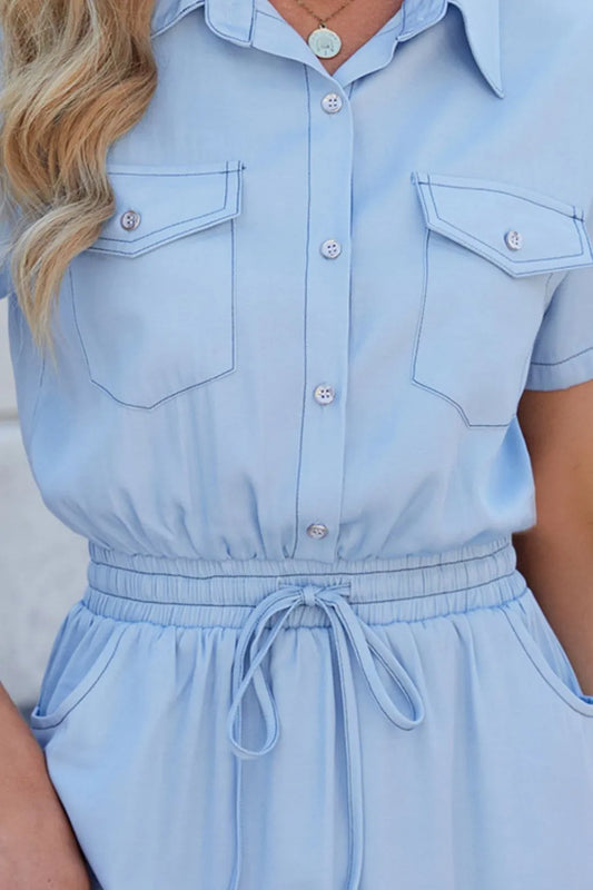 Light blue romper with short sleeves and button details.