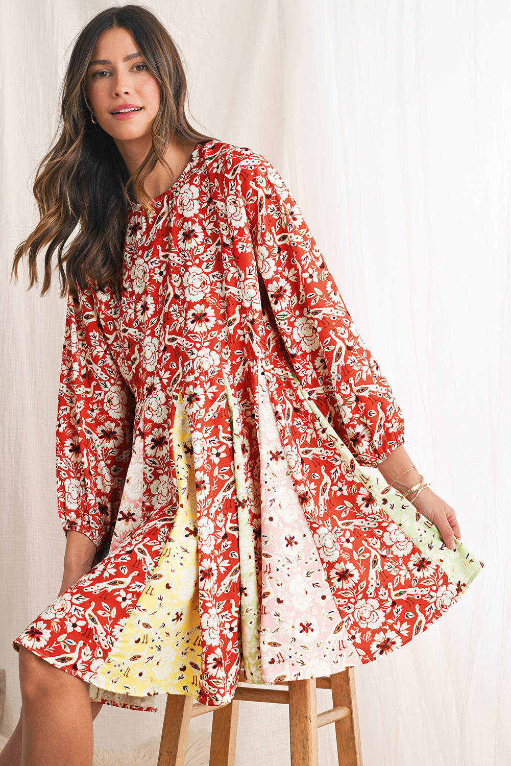 Woman wearing a red floral dress on a white background