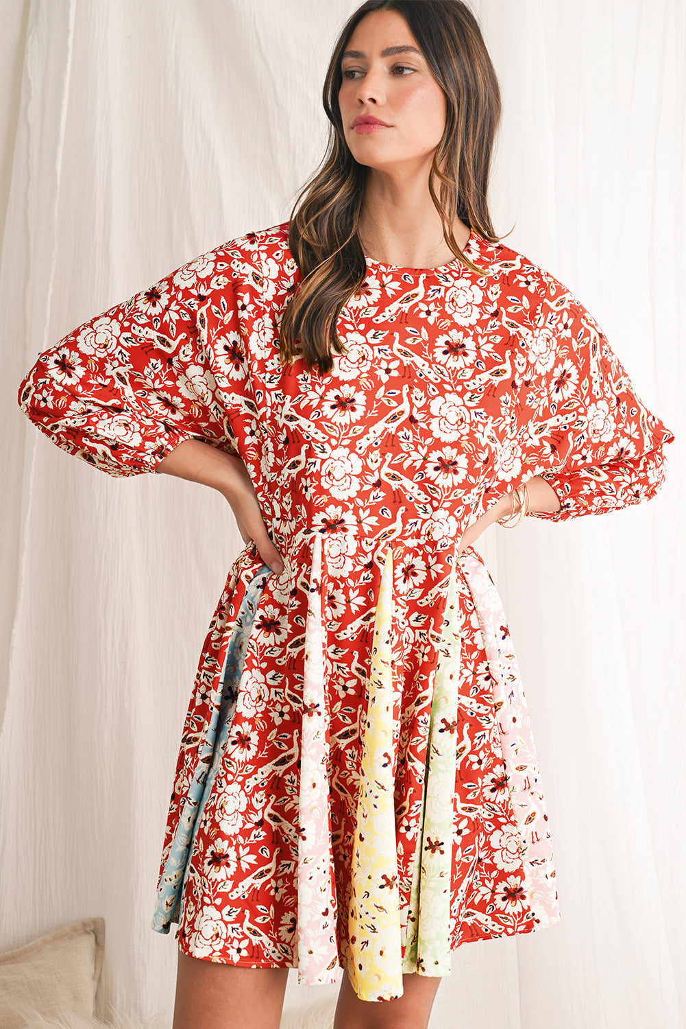 Woman wearing a red floral dress with a white background