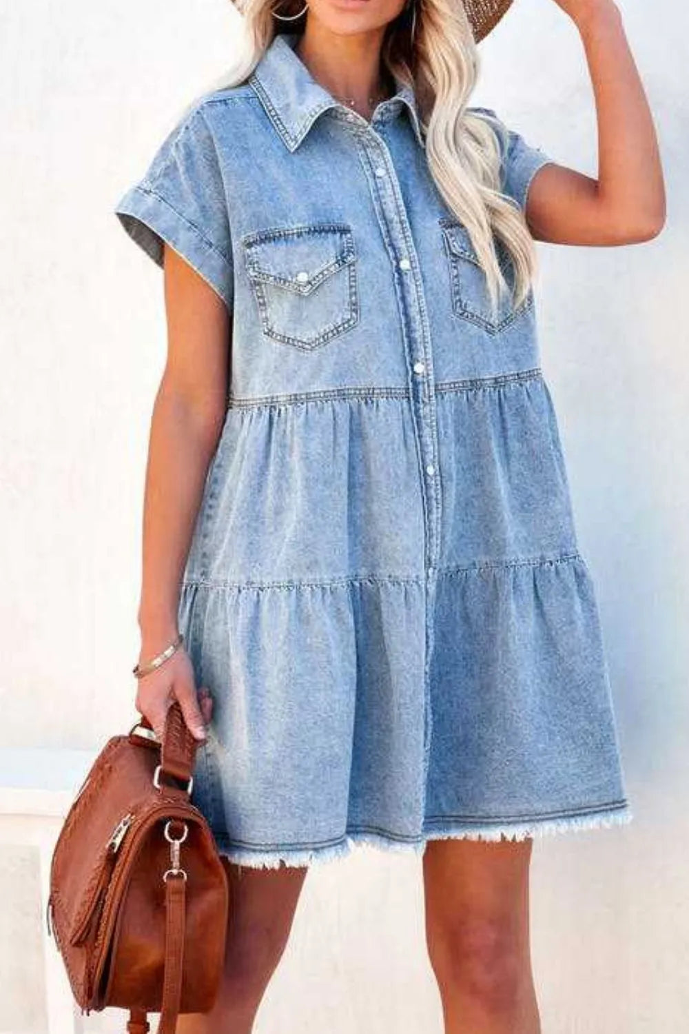 Woman wearing a denim dress with a plain background