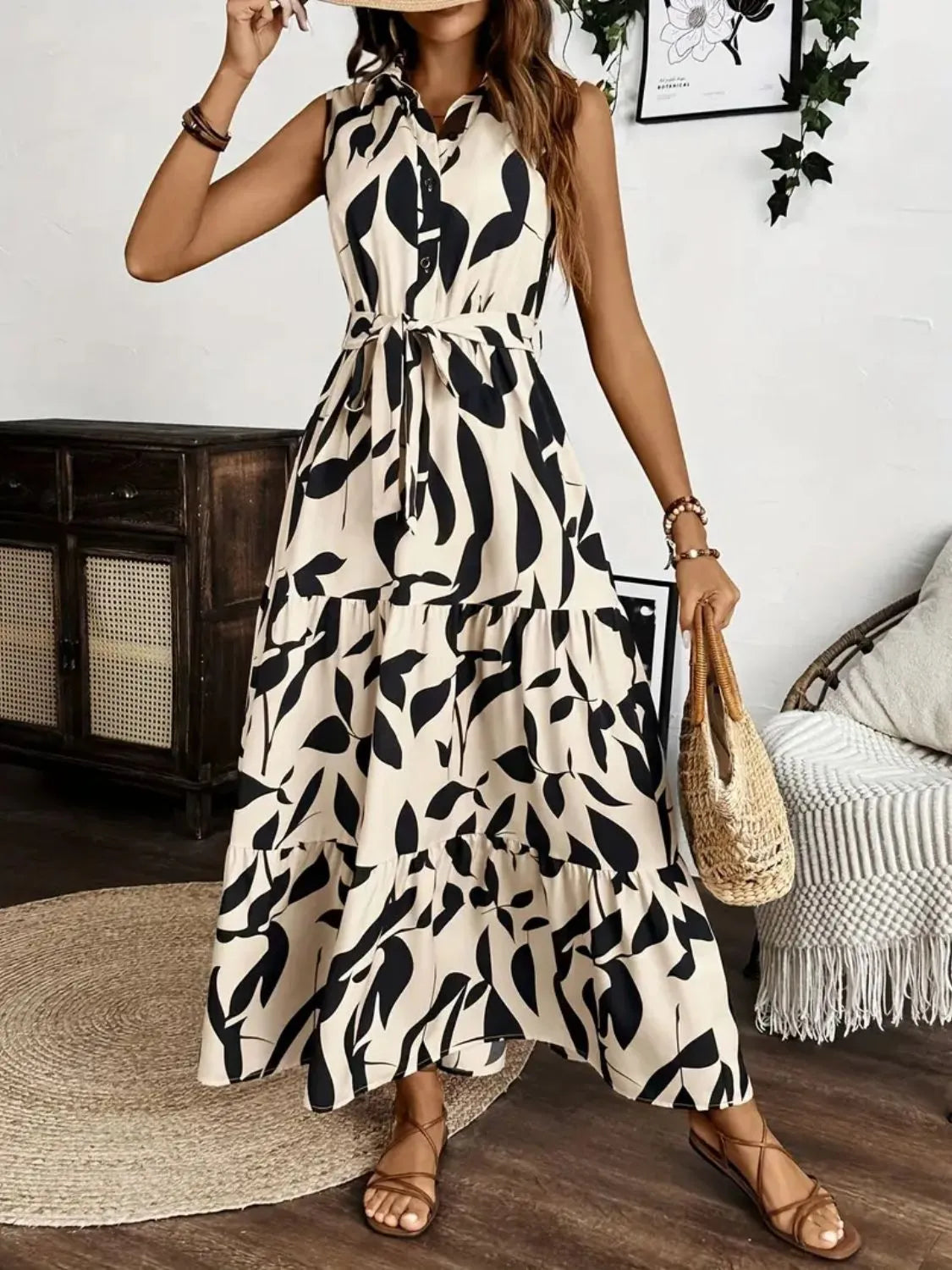 Woman wearing a black and white patterned dress in a home setting.