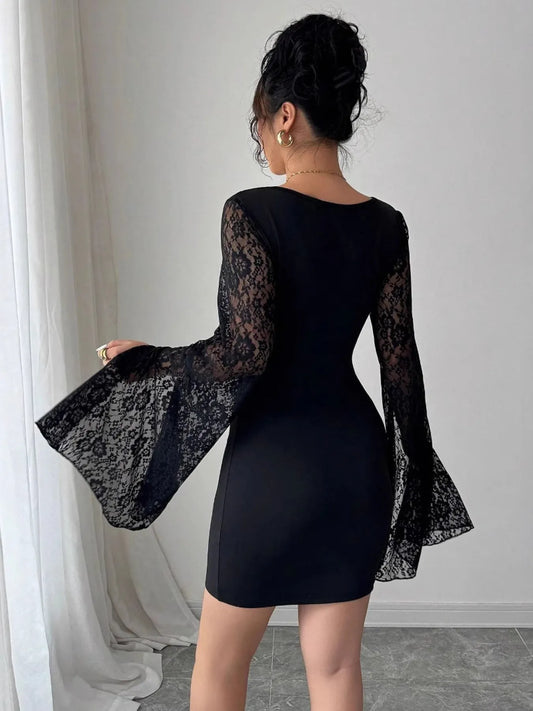 Black lace dress with long sleeves worn by a person against a neutral background