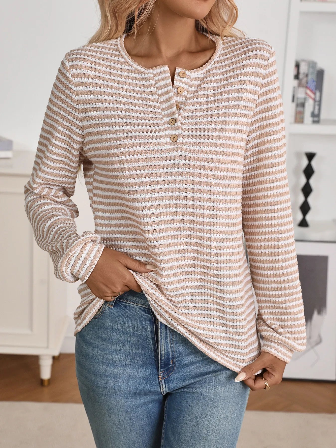person wearing a long sleeve striped blouse