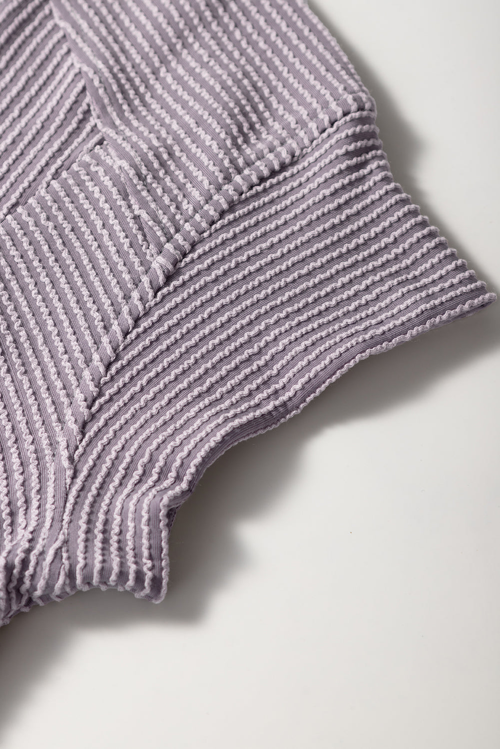Close-up of a textured purple fabric on a white background