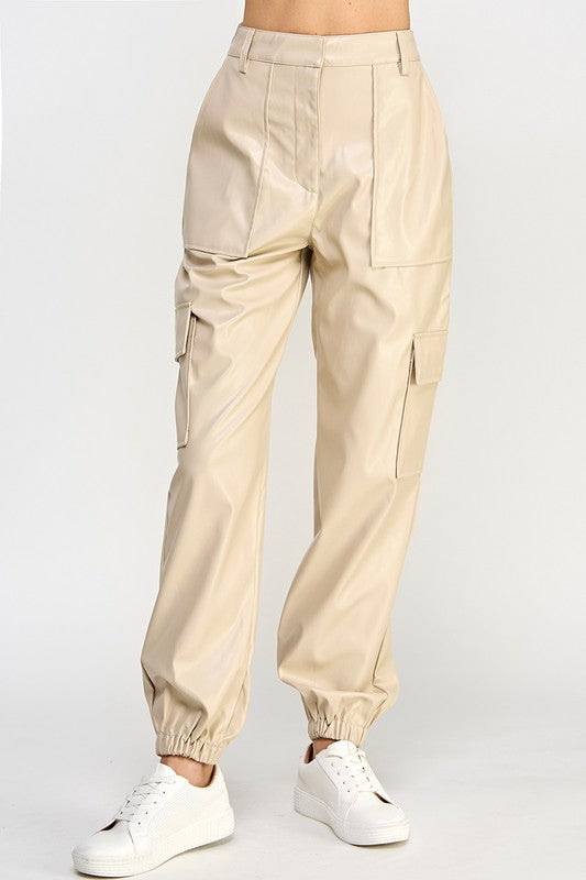 Beige cargo pants worn by a person on a white background