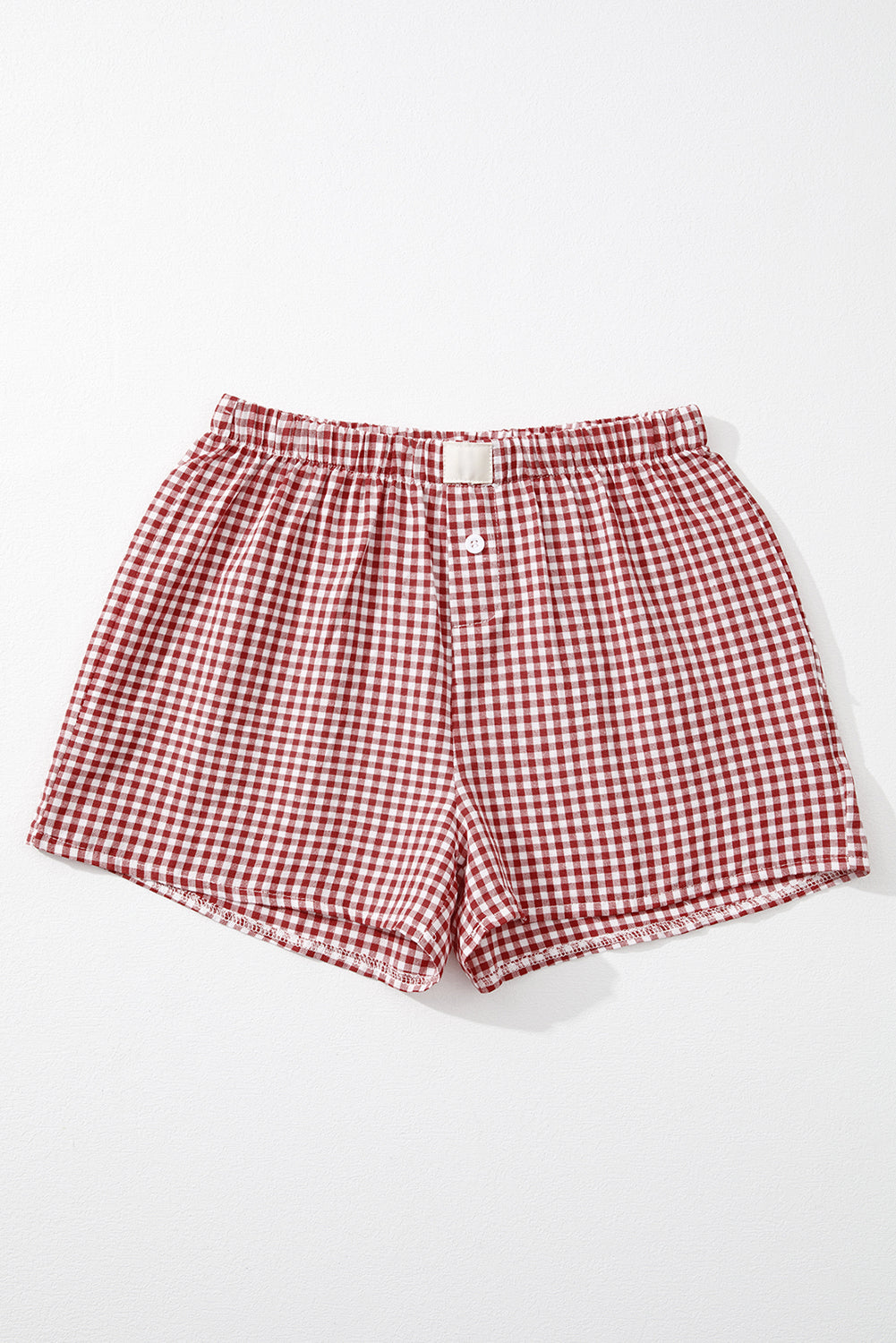 Red and white checkered shorts on a white background