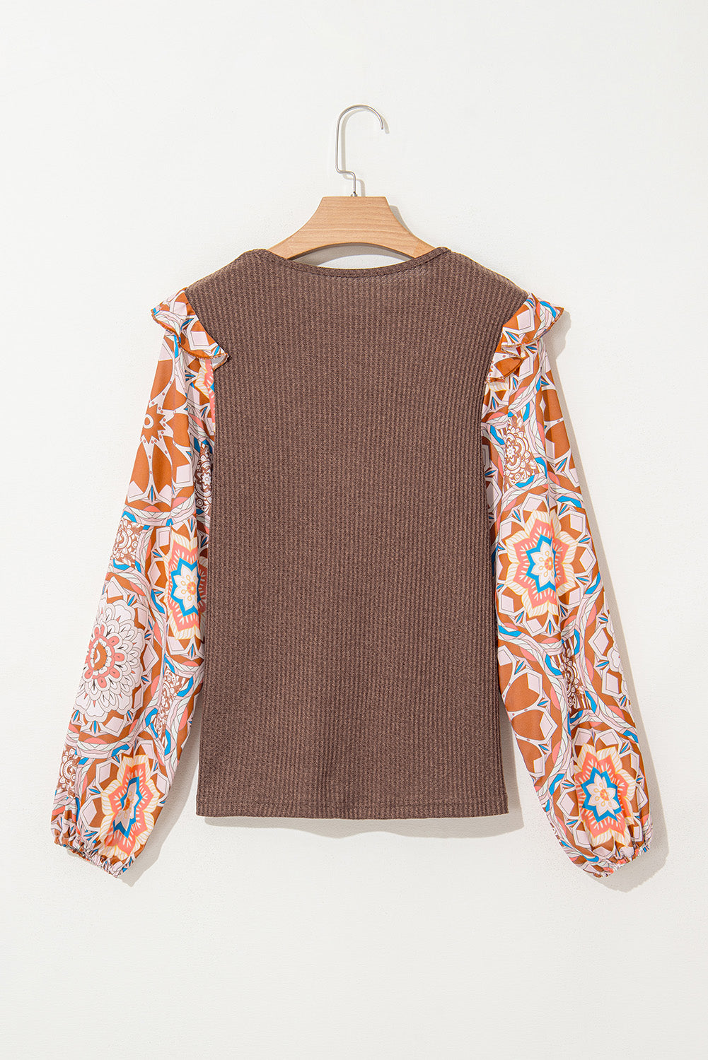 Brown ribbed sweater with colorful patterned sleeves on a white background