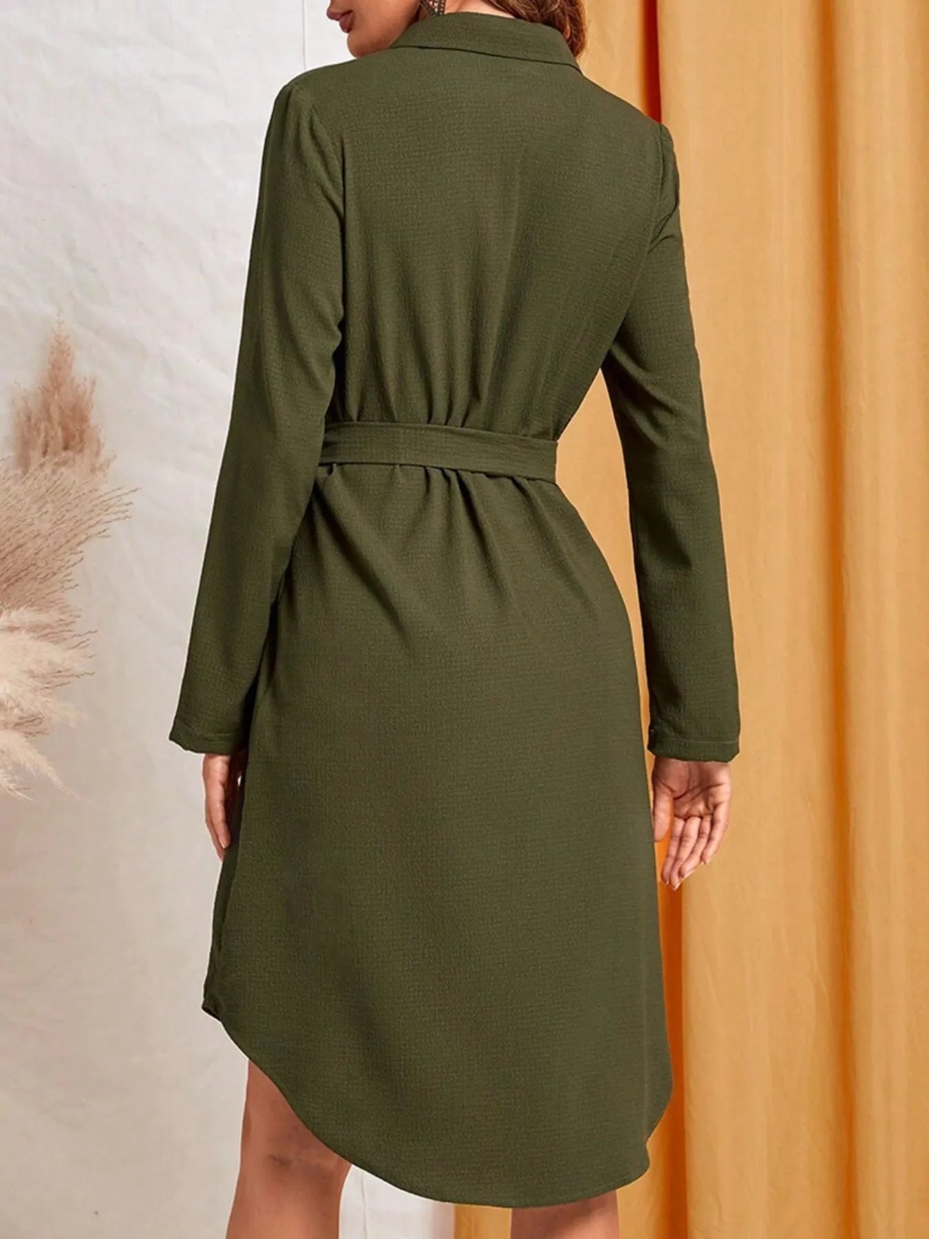 Green dress worn by a person with a neutral background