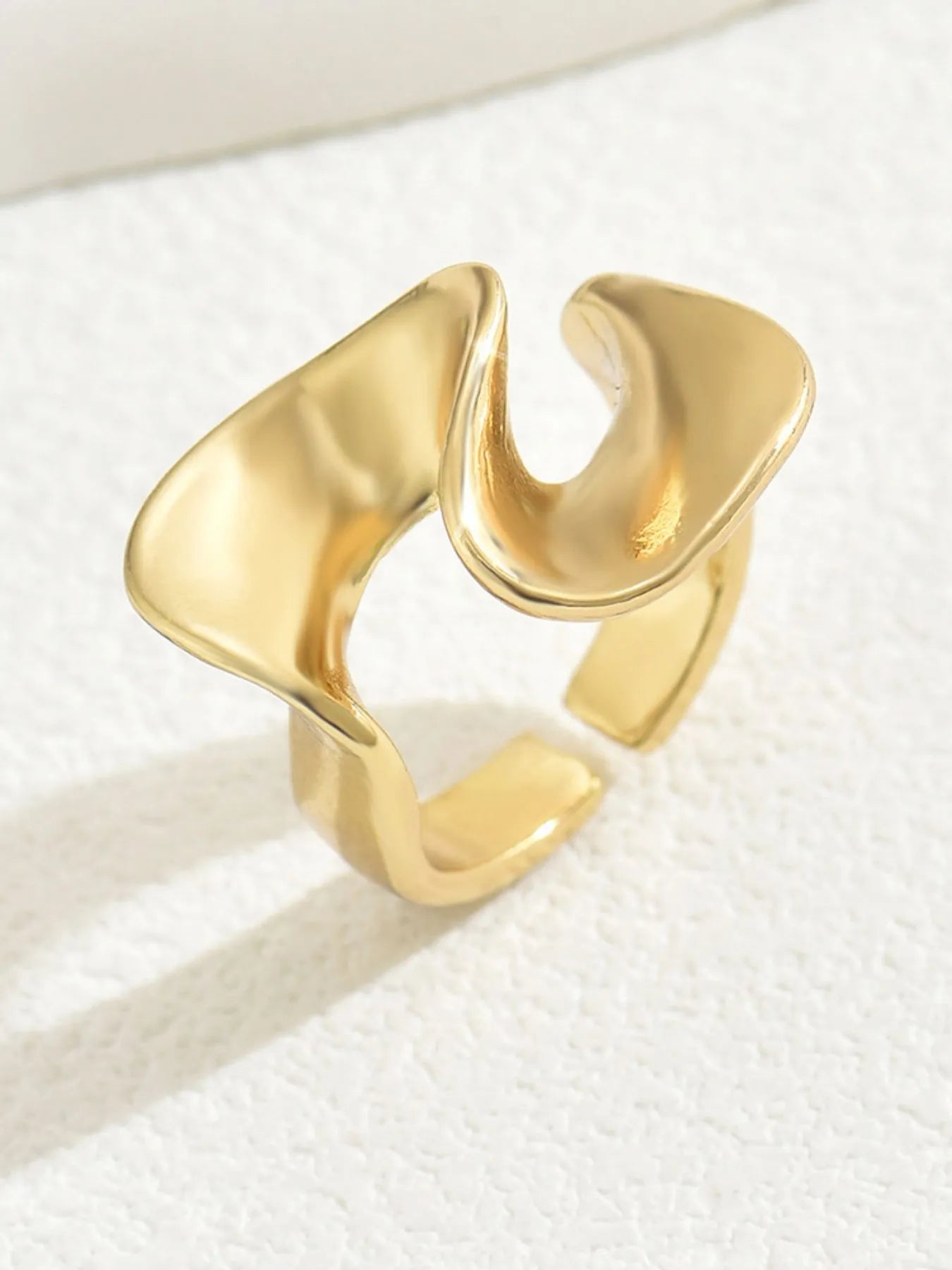 Gold open ring on a white background