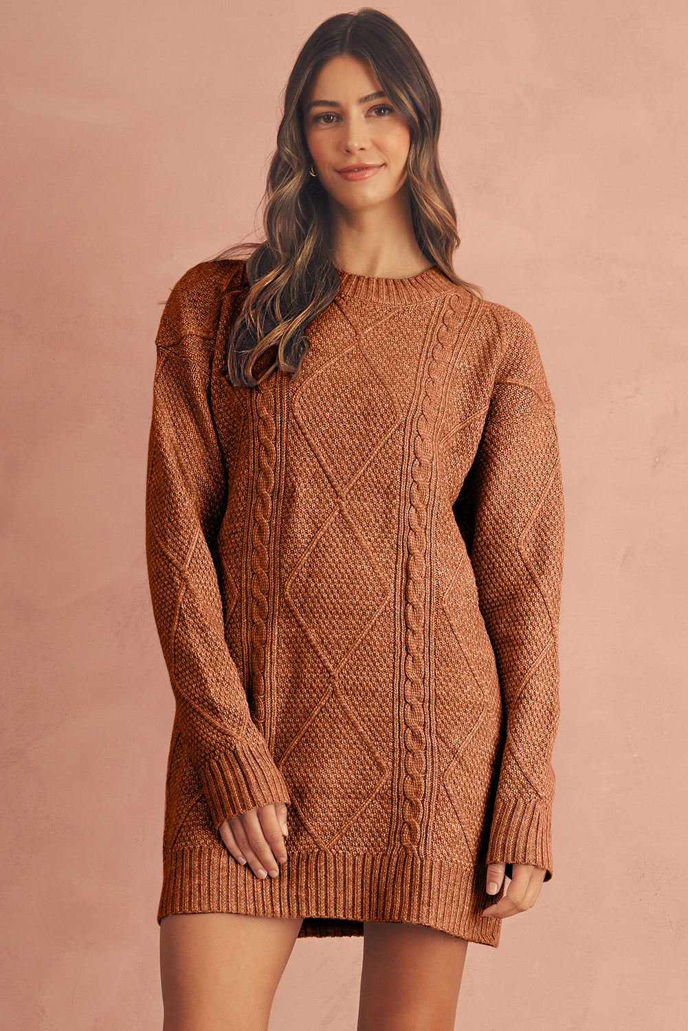 Woman wearing a brown cable knit sweater dress against a matching background