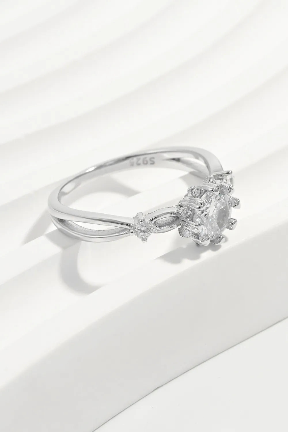 Silver ring with a diamond on a white background