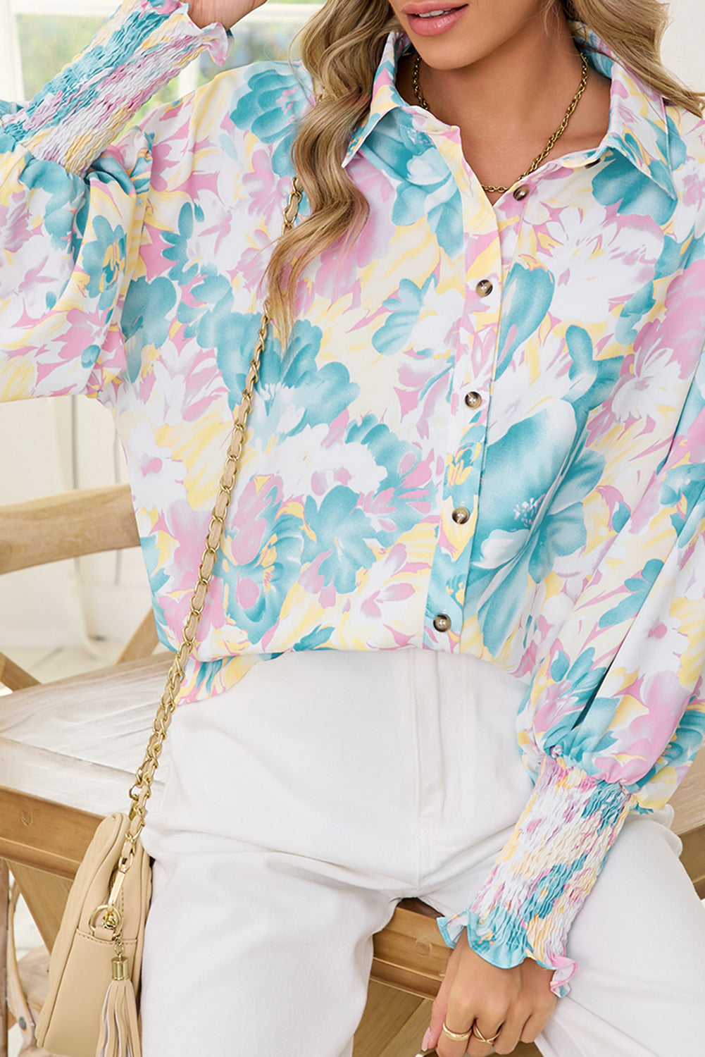 Person wearing a colorful floral shirt with a blurred background