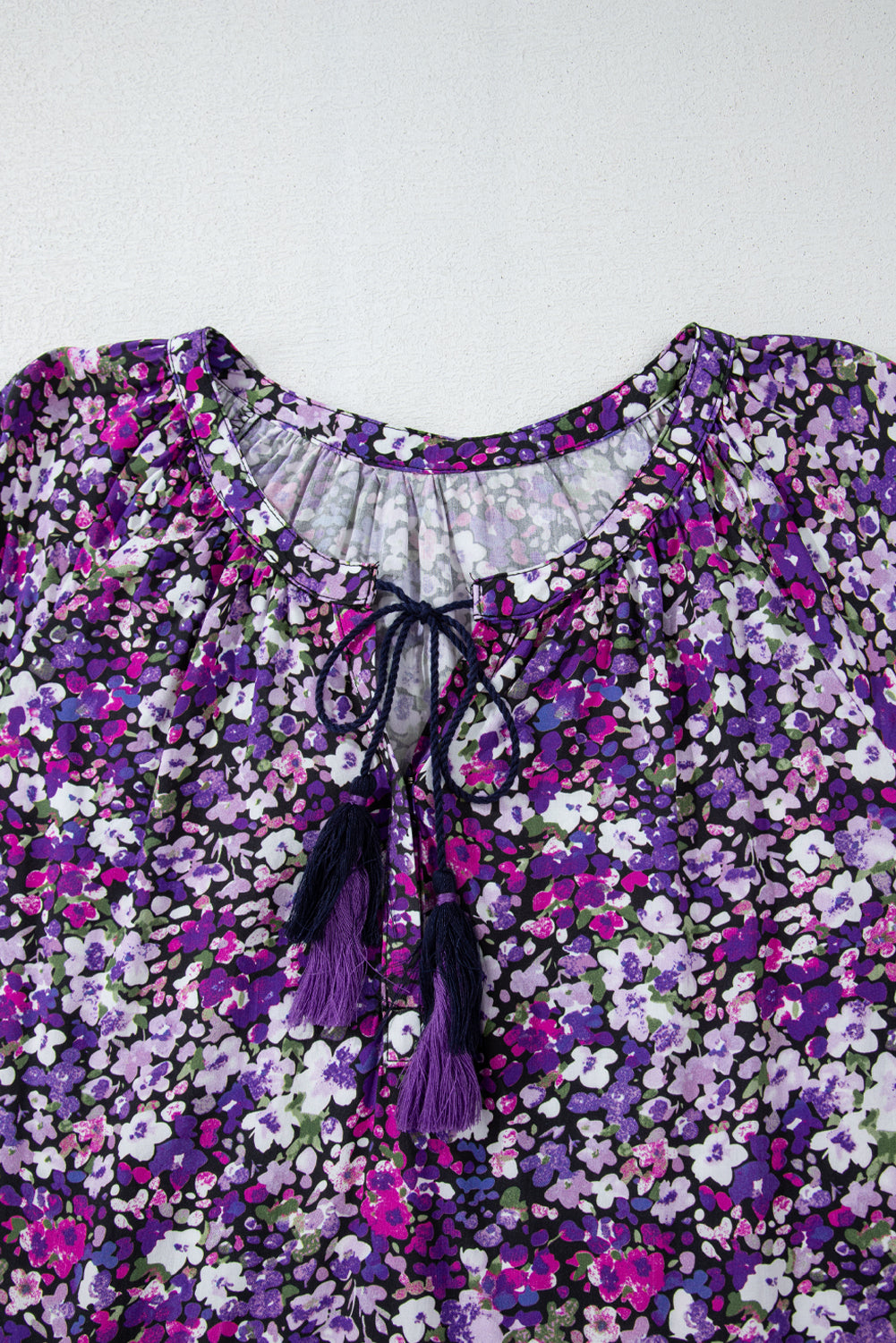 Floral blouse with purple accents on a white background