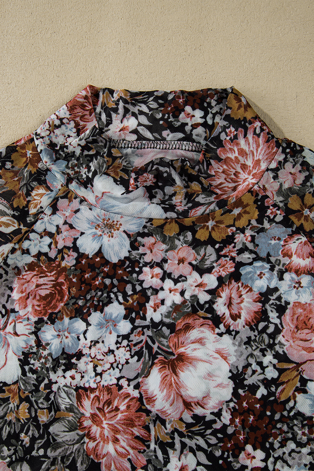 Floral patterned shirt on a beige background