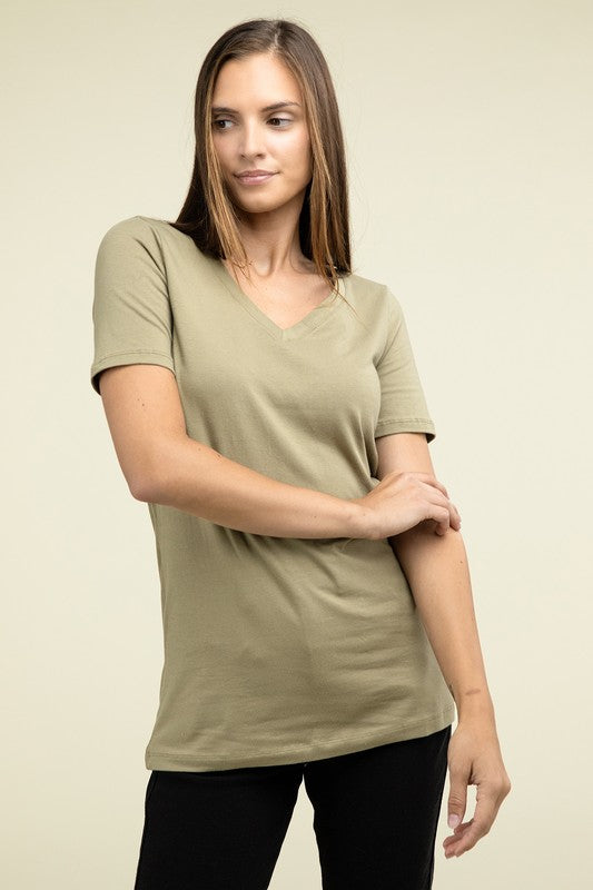 Woman wearing a green t-shirt against a beige background