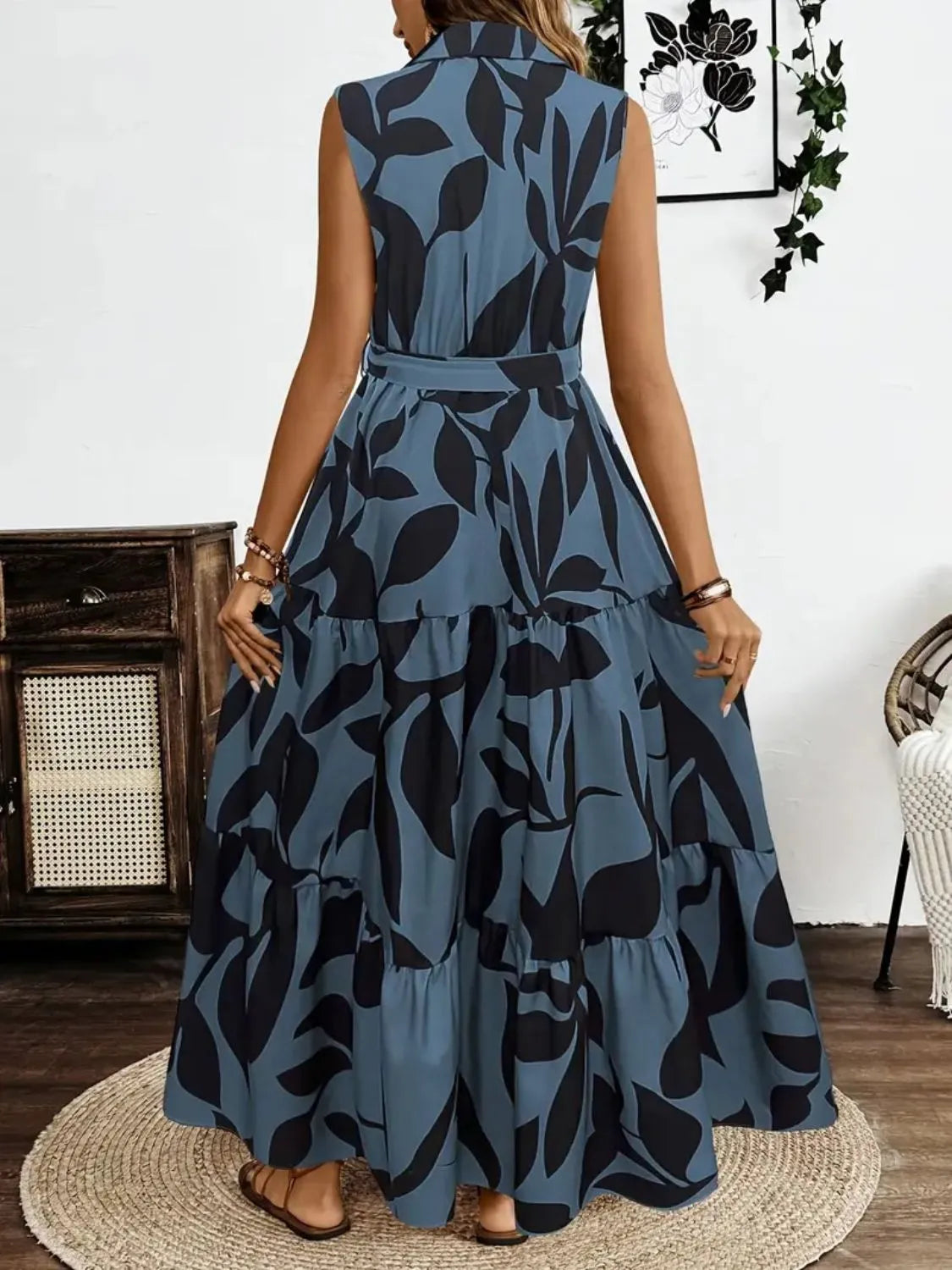 Woman wearing a blue and black patterned dress indoors.