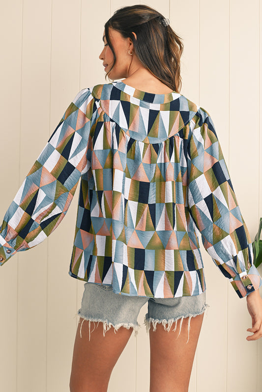 Woman wearing a geometric patterned shirt with a neutral background
