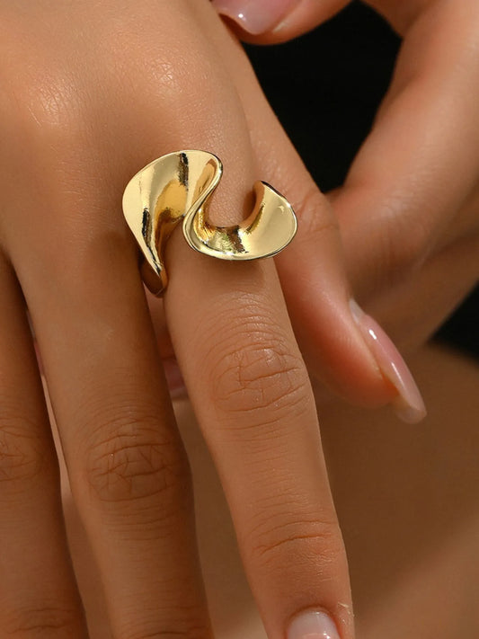 Gold ring on a finger with a blurred background