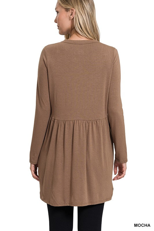 Woman wearing a brown dress with a plain background