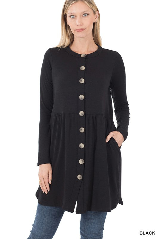 Woman wearing a black button-up dress with a white background