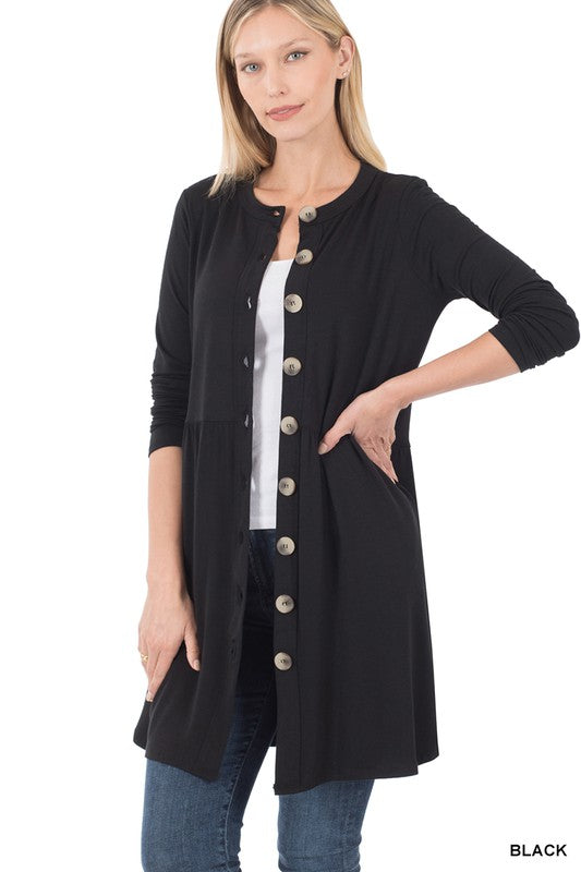 Woman wearing a black cardigan with buttons on a white background