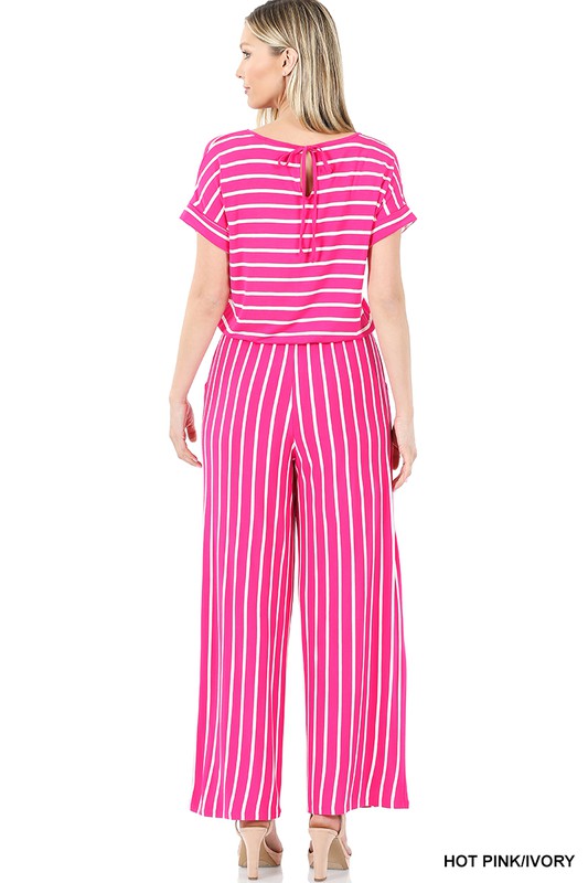 Woman wearing a pink and white striped jumpsuit on a white background