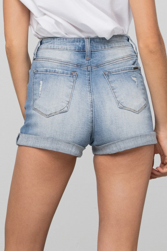 Light blue denim shorts worn by a person on a plain background