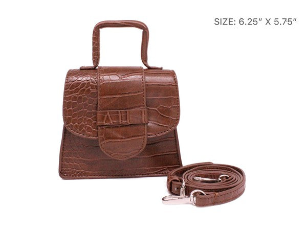 Brown crocodile-patterned handbag with matching strap on a white background