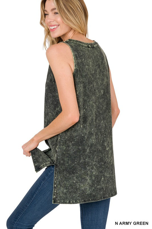 Woman wearing an acid-wash denim sleeveless top with blue jeans on a white background