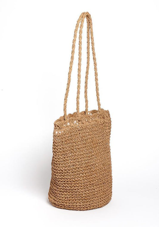 Woven straw bag with sequins on a white background