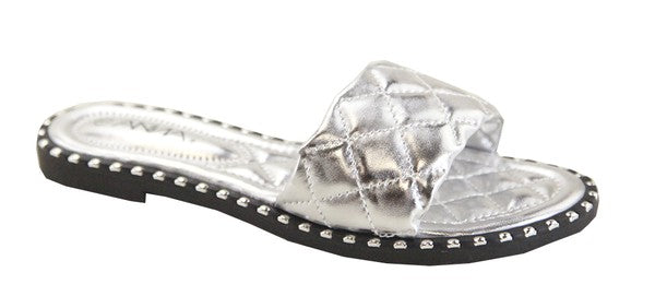 Silver sandal with clear gemstone on a white background