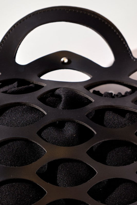 Close-up of a black metal reel with a white background