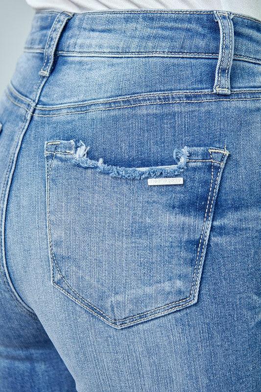 Close-up of blue jeans with a visible brand label on the pocket.