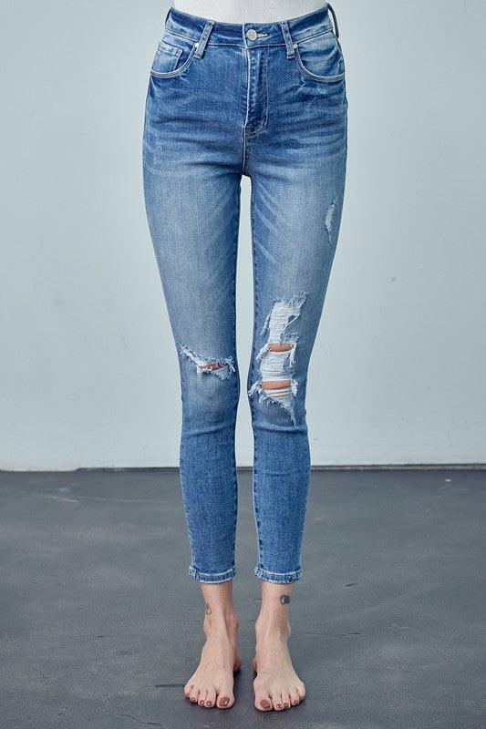 Blue distressed jeans on a plain background