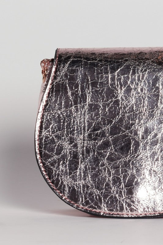 Close-up of a textured metallic pouch on a light gray background