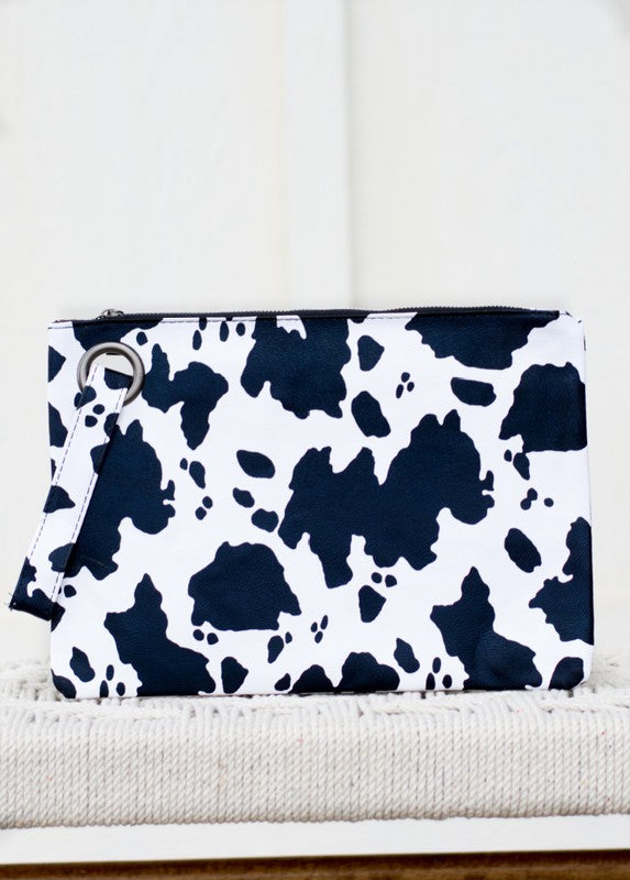 Cow print pouch on a white surface