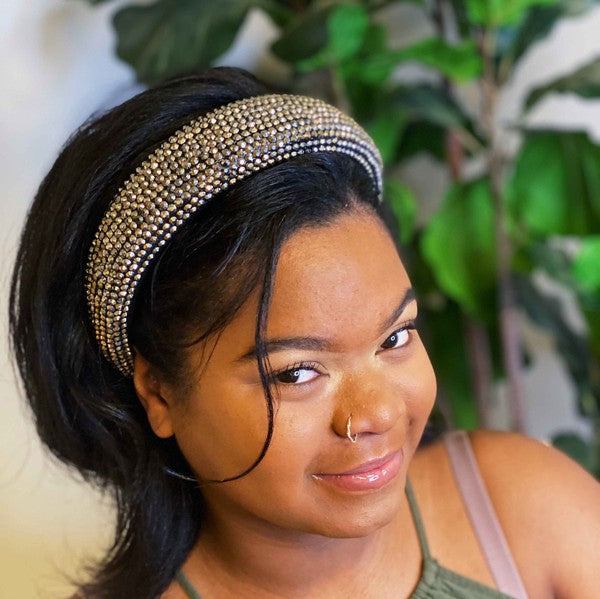 Woman wearing a decorative headband with plants in the background