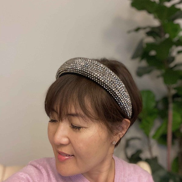 Woman wearing a decorative headband with a blurred indoor background