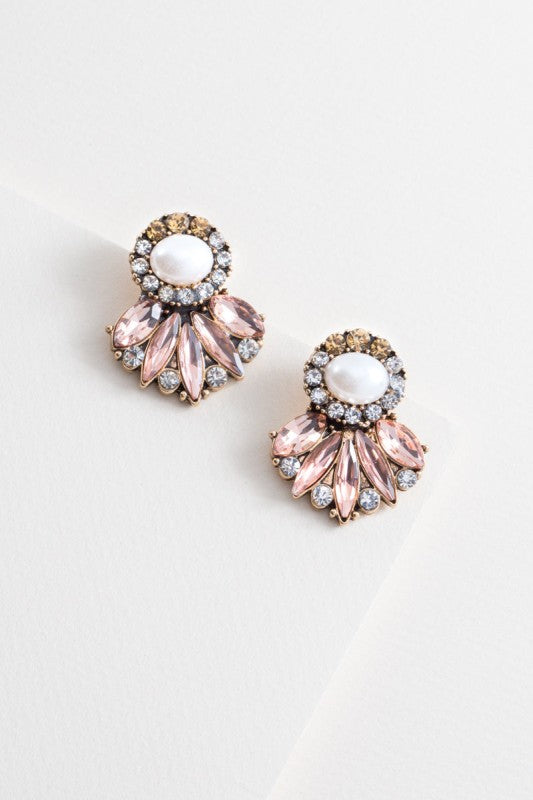 Pair of pink and gold earrings on a light gray background