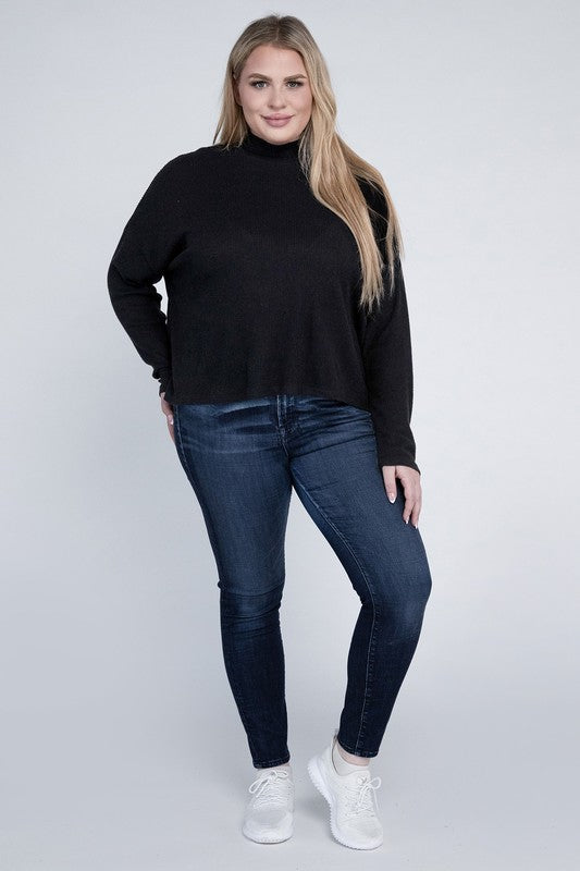 Woman wearing a black turtleneck sweater and blue jeans on a white background