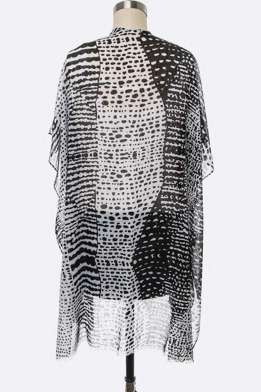 Black and white patterned kimono-style garment on a mannequin against a white background