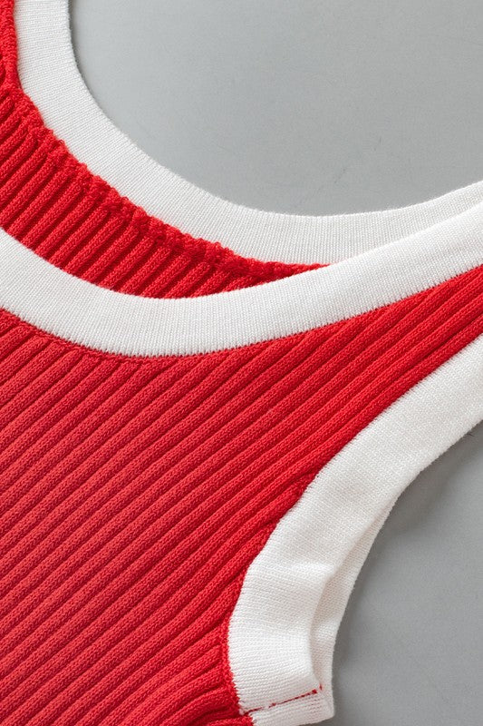 Close-up of a red and white ribbed garment on a gray background