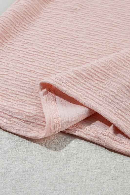 Close-up of pink textured fabric on a light gray background