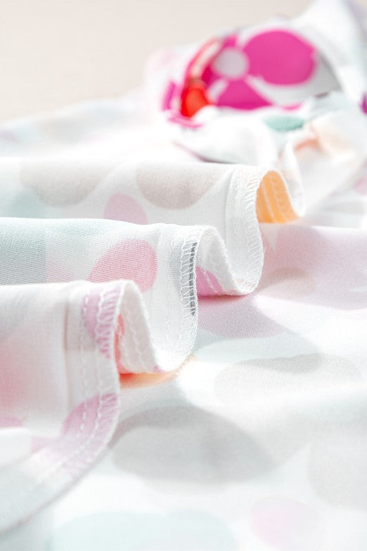 Close-up of a soft, textured fabric with colorful polka dots on a light background