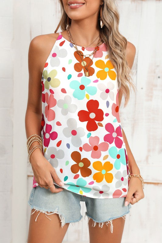 Woman wearing a colorful floral tank top against a white background