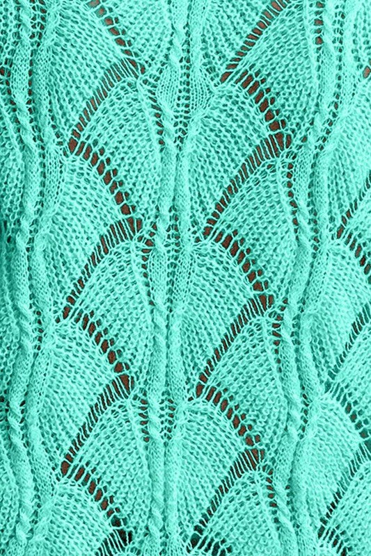 Close-up of a textured teal fabric with a diamond pattern