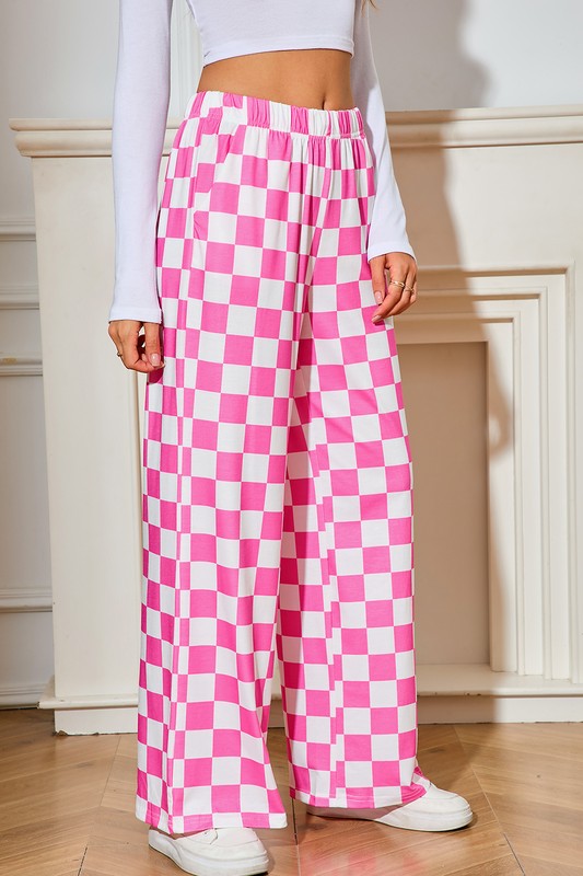 Person wearing pink and white checkered pants indoors.