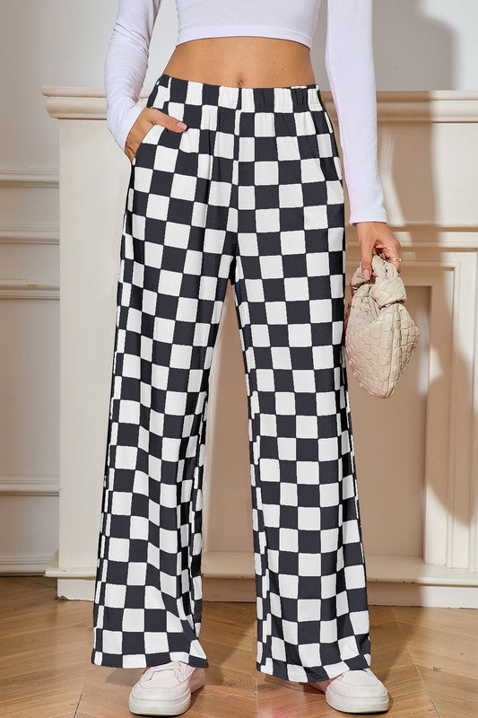 Person wearing black and white checkered pants with a blurred background