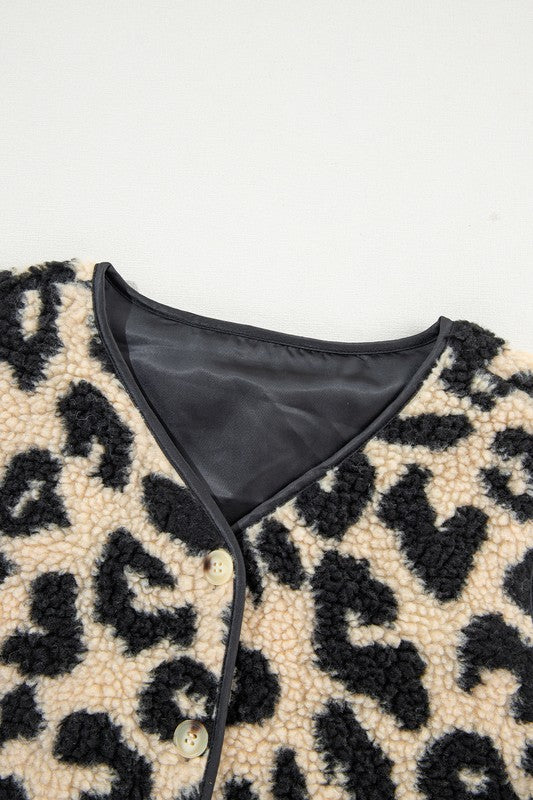 Close-up of a leopard print garment with a black interior lining on a white background