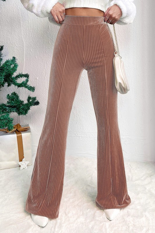Brown ribbed wide-leg pants worn by a person with a white background